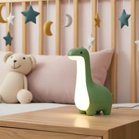 Veilleuse dinosaure bébé verte en silicone diffusant une lumière apaisante pour le sommeil